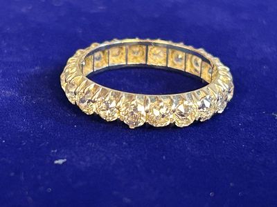 a close up of a gold ring on a blue surface