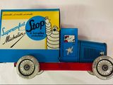 un camion jouet posé sur une surface blanche