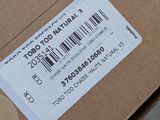 a brown box with a barcode on it sitting on the ground