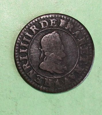 a close up of a coin on a green surface