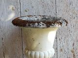 a white vase sitting on top of a wooden table