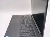 a laptop computer sitting on a table with a keyboard