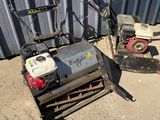 a small machine that is sitting on the ground next to a building