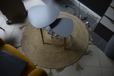 two tables on a round rug in a living room