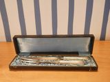a silverware set in a black case on a table