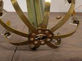 a sculpture made of metal and glass on a wooden floor