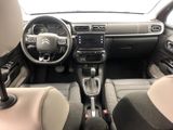 the interior of a small car with a steering wheel and dashboard