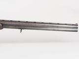 a rifle with a wooden barrel and a metal barrel