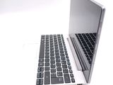 a laptop computer with a keyboard on a white surface
