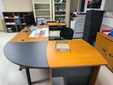 a desk that has a box on it in the middle of the room