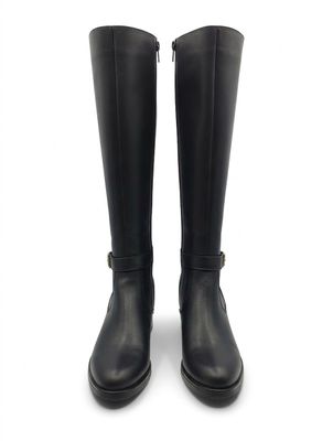pair of black rain boots on a white surface with a white background