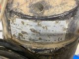 a close up of a gas can with a hose attached to it