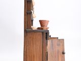 a small wooden cabinet with a bowl on top of it