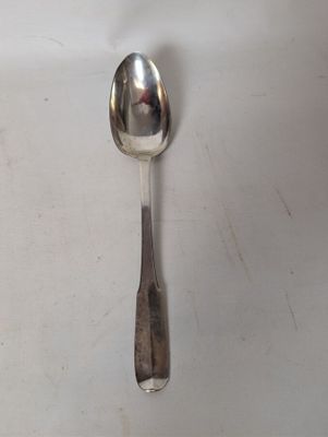a spoon and a spoon rest on a white surface