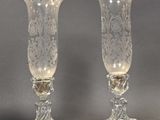 pair of clear glass vases sitting on top of a table