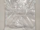 a white shirt in a plastic bag on a white surface