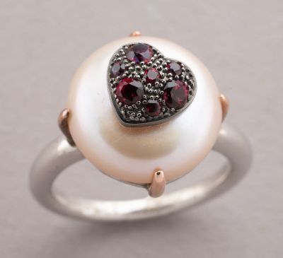 an image of a pearl ring with garnets and a heart