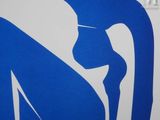 a blue and white picture of a woman sitting on a surfboard