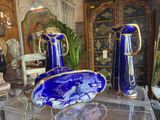 two blue vases sitting on top of a clear table