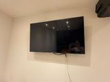a flat screen tv mounted on the wall in a room