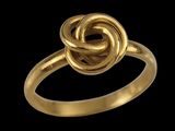 a close up of a gold ring on a black background