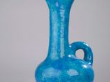 a blue vase that is sitting on a table