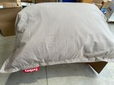 a pillow that is sitting on top of a cardboard box
