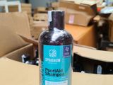a bottle of shampoo sitting on top of a cardboard box