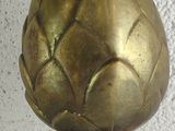 pair of brass artichokes on a marble table