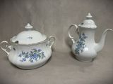 two white teapots with blue flowers on them