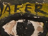 a close up of a painting of an eye on a wall