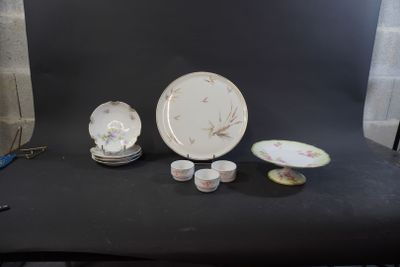 a black table with a plate, cups and saucers on it