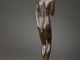 a bronze statue of a woman standing on a marble base