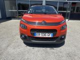 the orange citrole is parked in front of a building