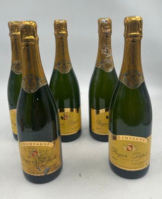 four bottles of champagne are lined up on a white surface