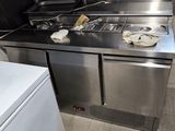 a small kitchen with a stove, refrigerator and dishwasher