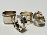 three silver napkins and two silver napkins on a white surface