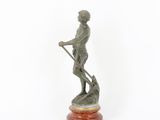 statue of a man with a spear on a marble base