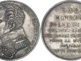 a close up of a coin with a picture of a man ' s face on it