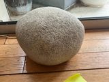 a rock sitting on a window sill next to a window sill