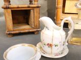 a tea pot and a cup sitting on a table