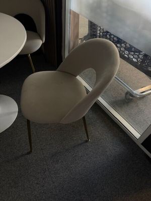two chairs and a table in front of a window
