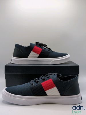 men ' s black sneakers with red, white and blue stripes on them