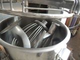an image of a large metal mixer in a kitchen