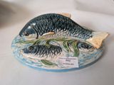 two fish on a plate with a price tag on it