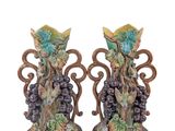 two vases with grapes on them on a white background