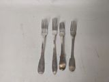 four forks and two spoons sitting on a table