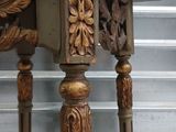 a wooden table with carvings on the top of it