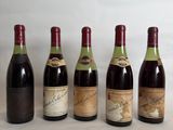 six bottles of wine lined up in a row on a table
