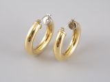 a pair of gold hoop earrings on a white background